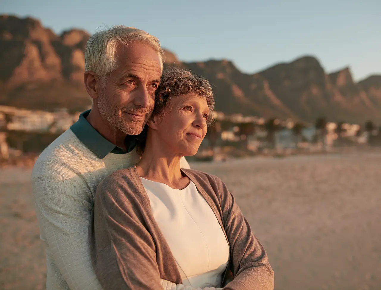 Elderly couple standing together on a beach