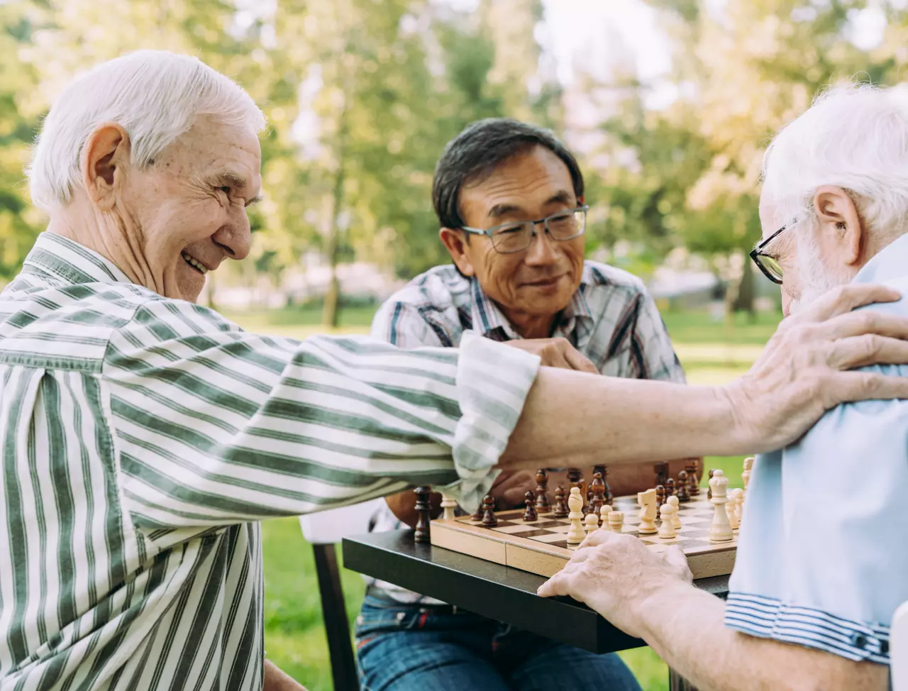 A group of senior friends playing chess