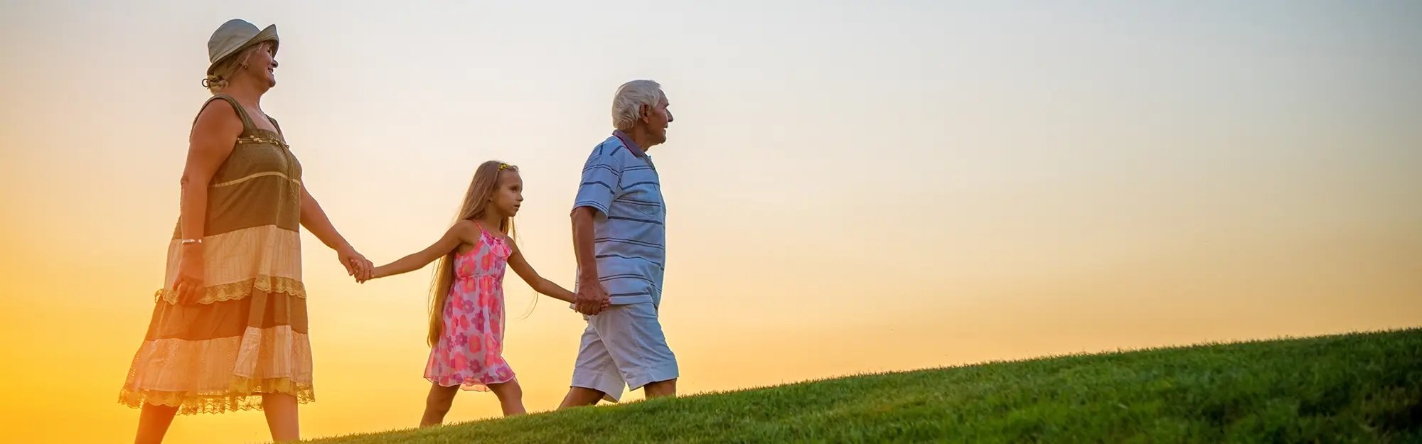 Young girl walking with grandparents