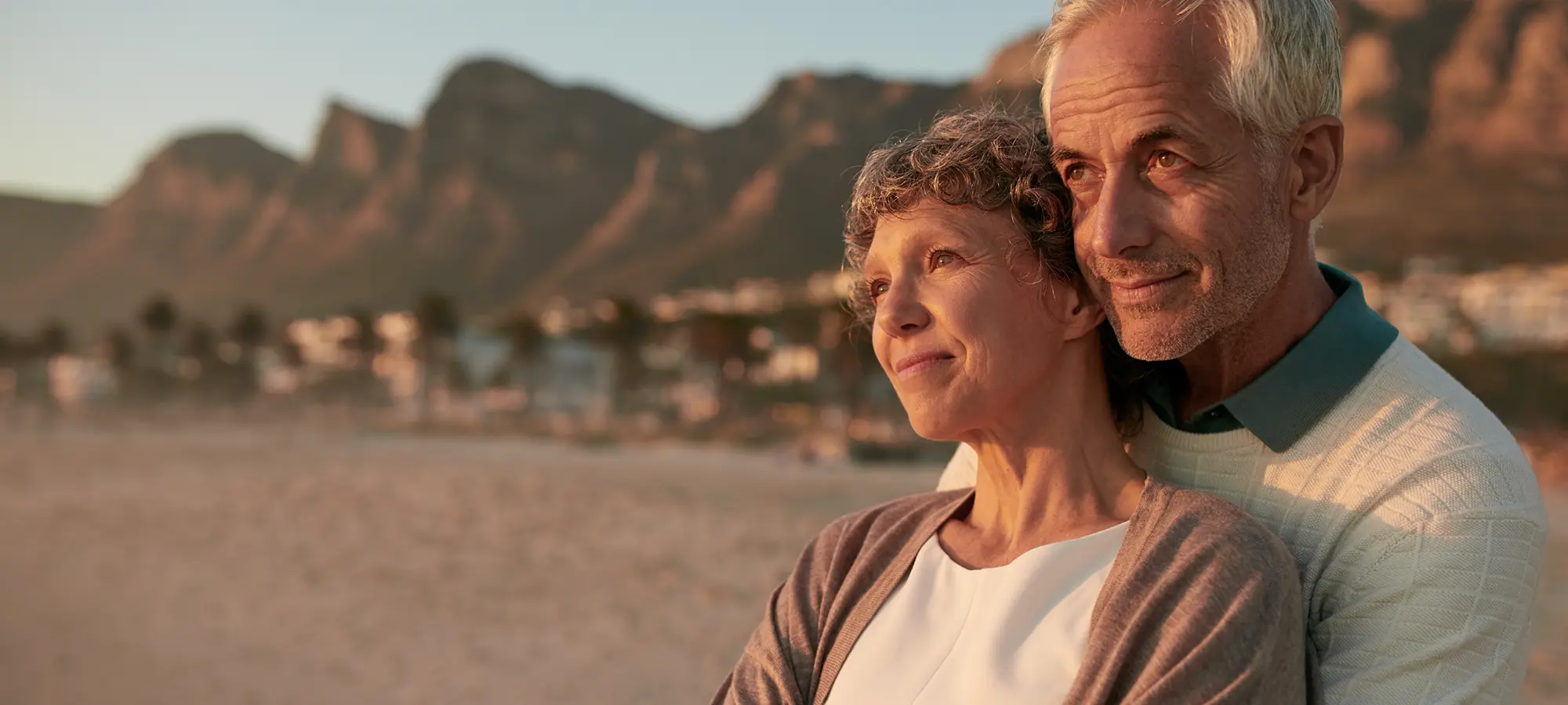 Elderly couple standing together on a beach