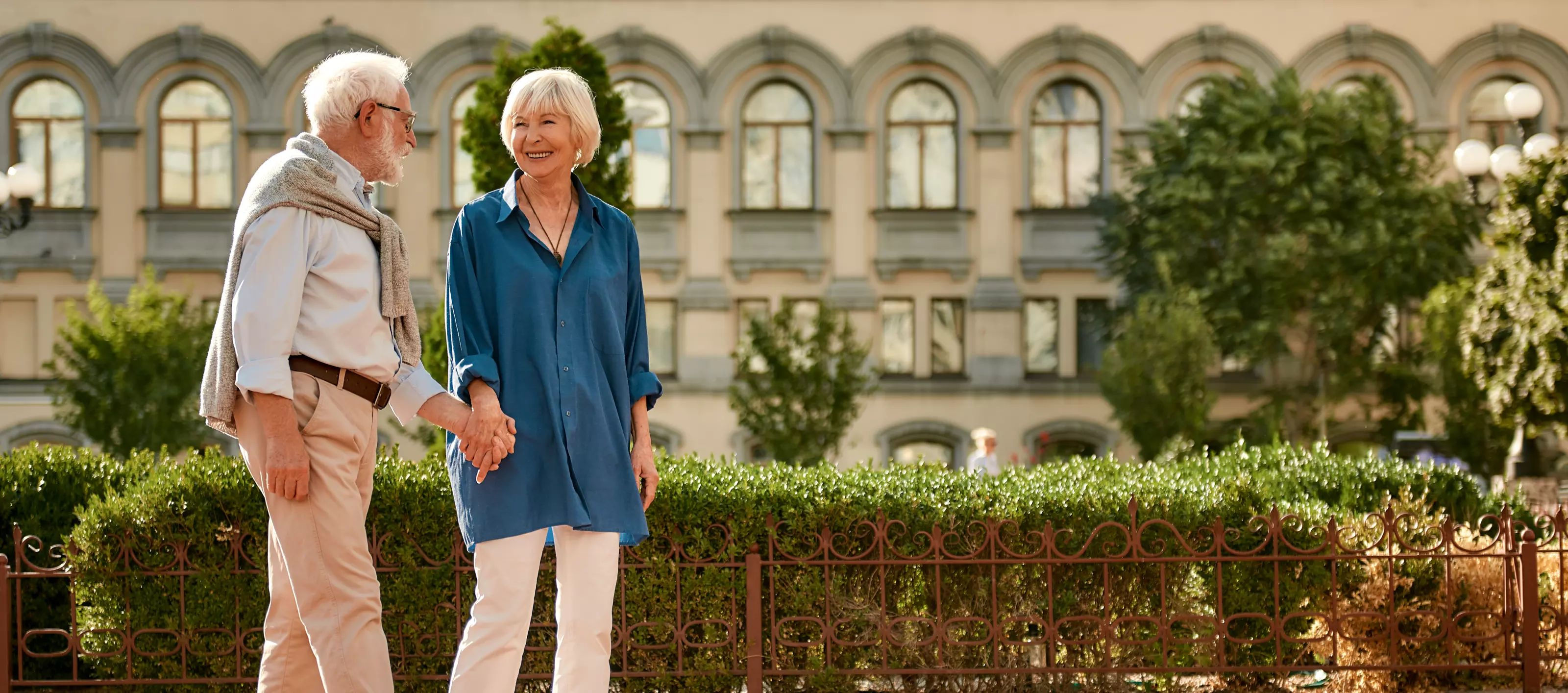 Elderly couple walking hand-in-hand