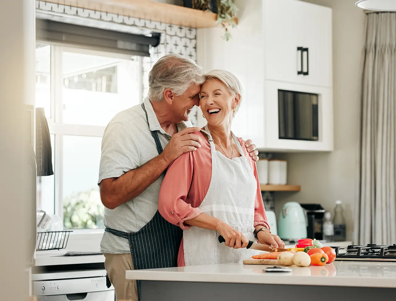 A senior couple cooking together in the kitchen